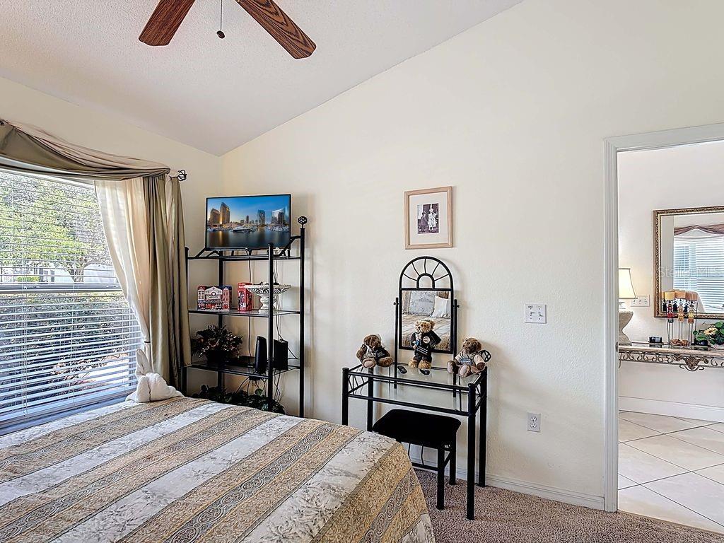 955 Lake Berkley Drive Kissimmee, FL 34746 - Photo 17 of 57 a bedroom with a bed and a table in it