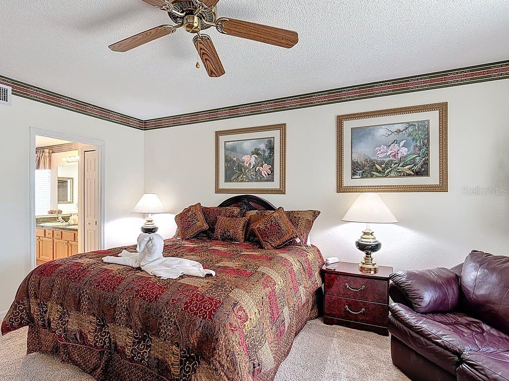 955 Lake Berkley Drive Kissimmee, FL 34746 - Photo 19 of 57 a bedroom with a bed couches and window