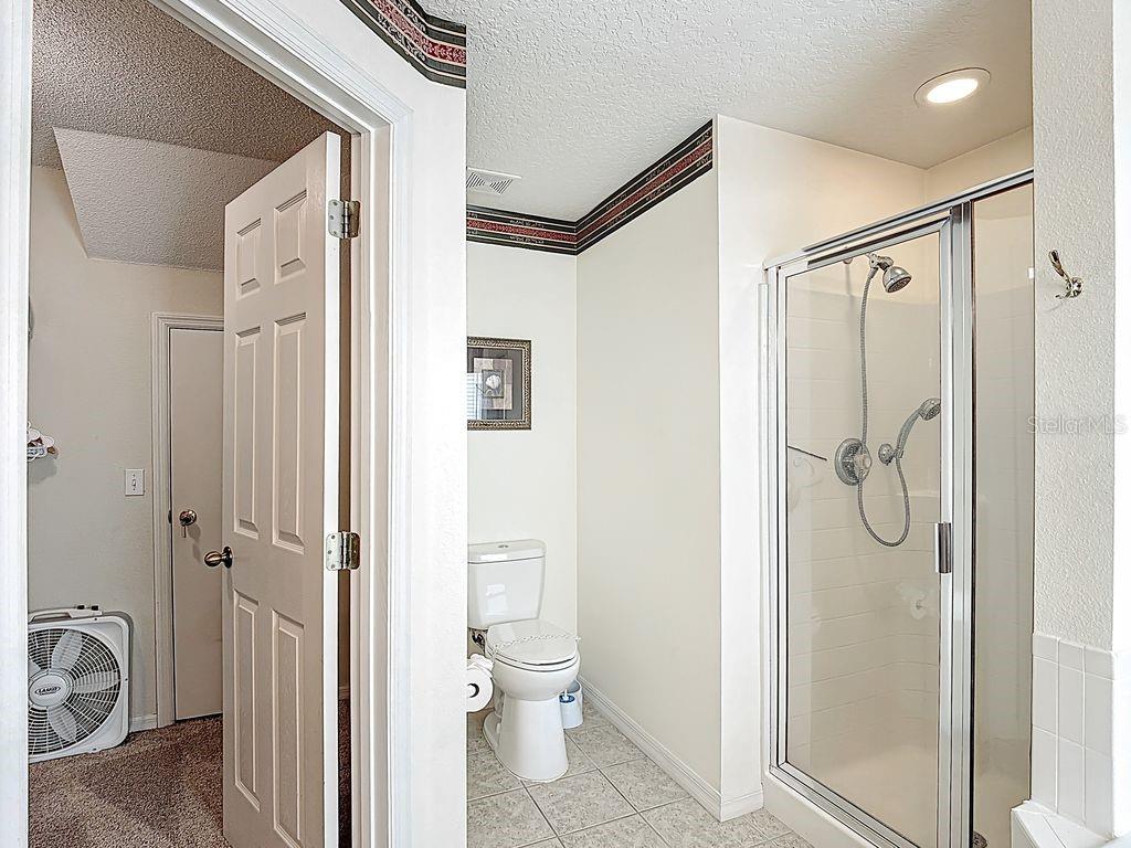 955 Lake Berkley Drive Kissimmee, FL 34746 - Photo 22 of 57 a bathroom with a granite countertop shower mirror and a toilet