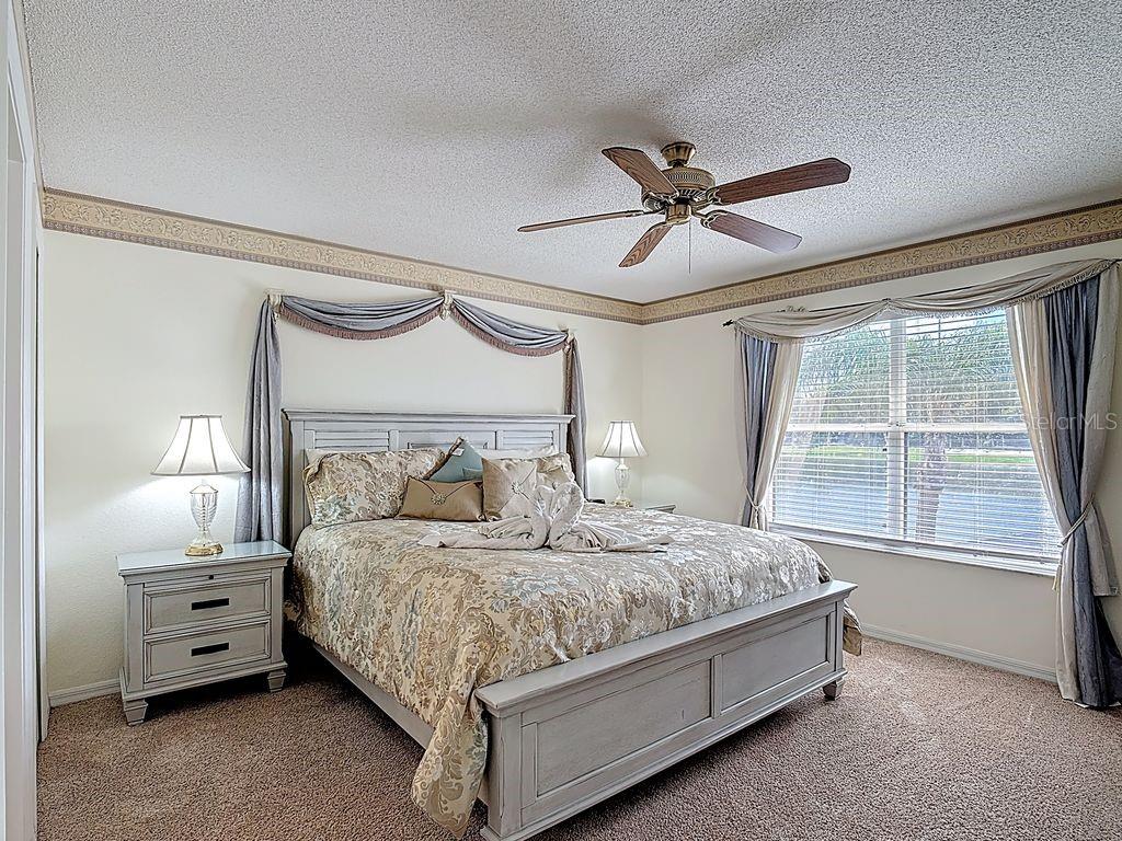 955 Lake Berkley Drive Kissimmee, FL 34746 - Photo 24 of 57 a bedroom with a bed and a large mirror