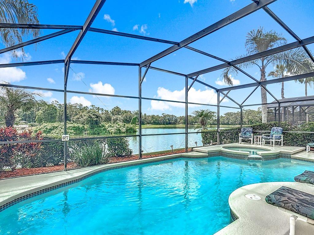 955 Lake Berkley Drive Kissimmee, FL 34746 - Photo 27 of 57 a view of a lake with a house in the background