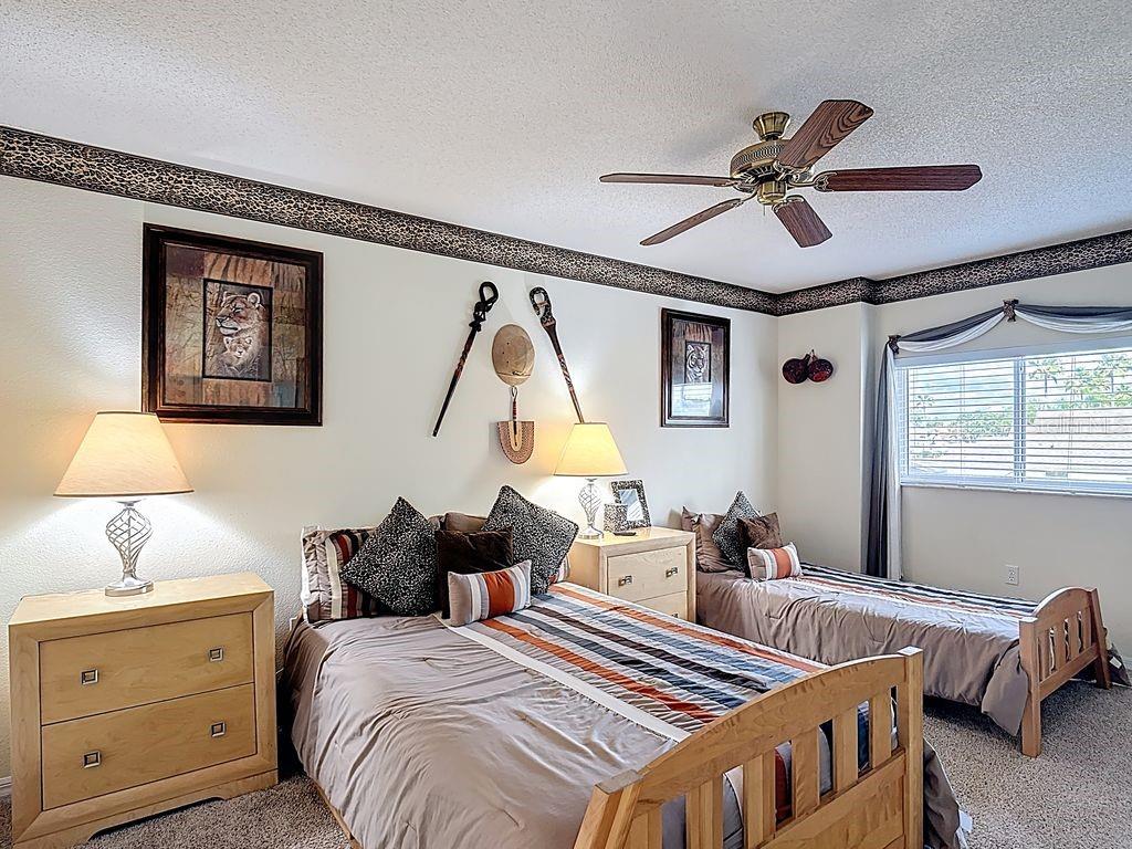 955 Lake Berkley Drive Kissimmee, FL 34746 - Photo 30 of 57 a bedroom with bed and a chandelier