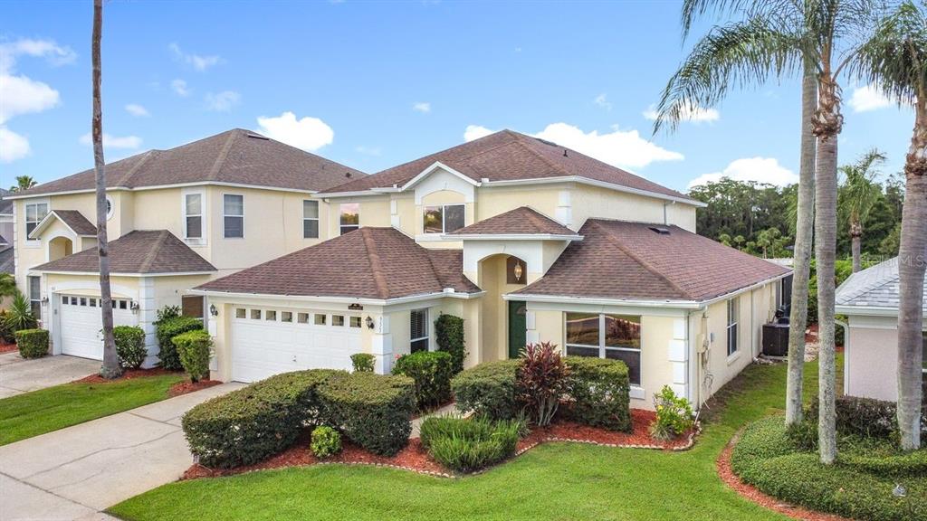 955 Lake Berkley Drive Kissimmee, FL 34746 - Photo 3 of 57 a front view of house with yard and green space
