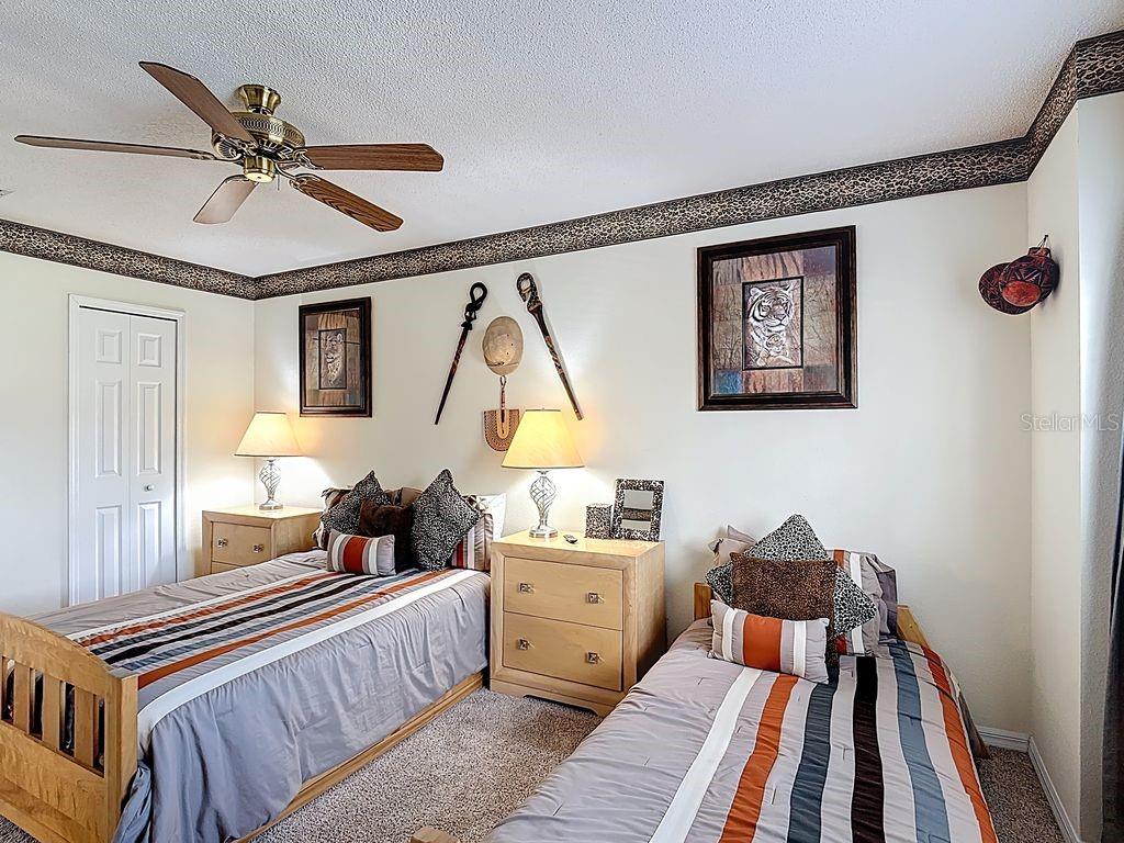 955 Lake Berkley Drive Kissimmee, FL 34746 - Photo 31 of 57 a bedroom with a bed and a chandelier