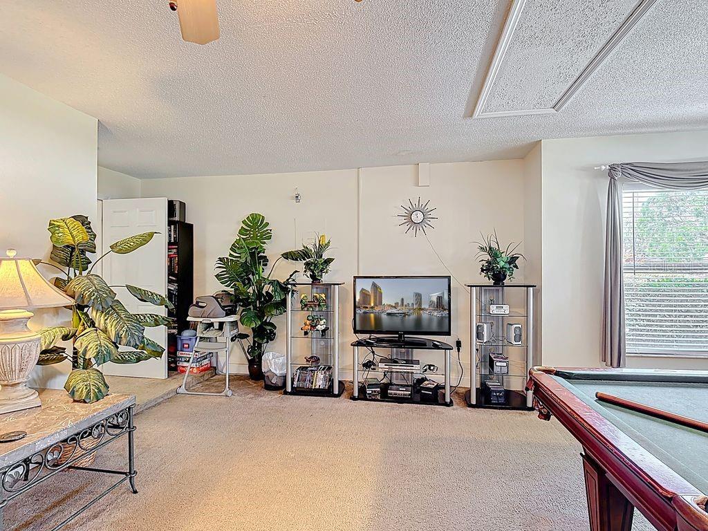 955 Lake Berkley Drive Kissimmee, FL 34746 - Photo 33 of 57 a living room with furniture and a flat screen tv