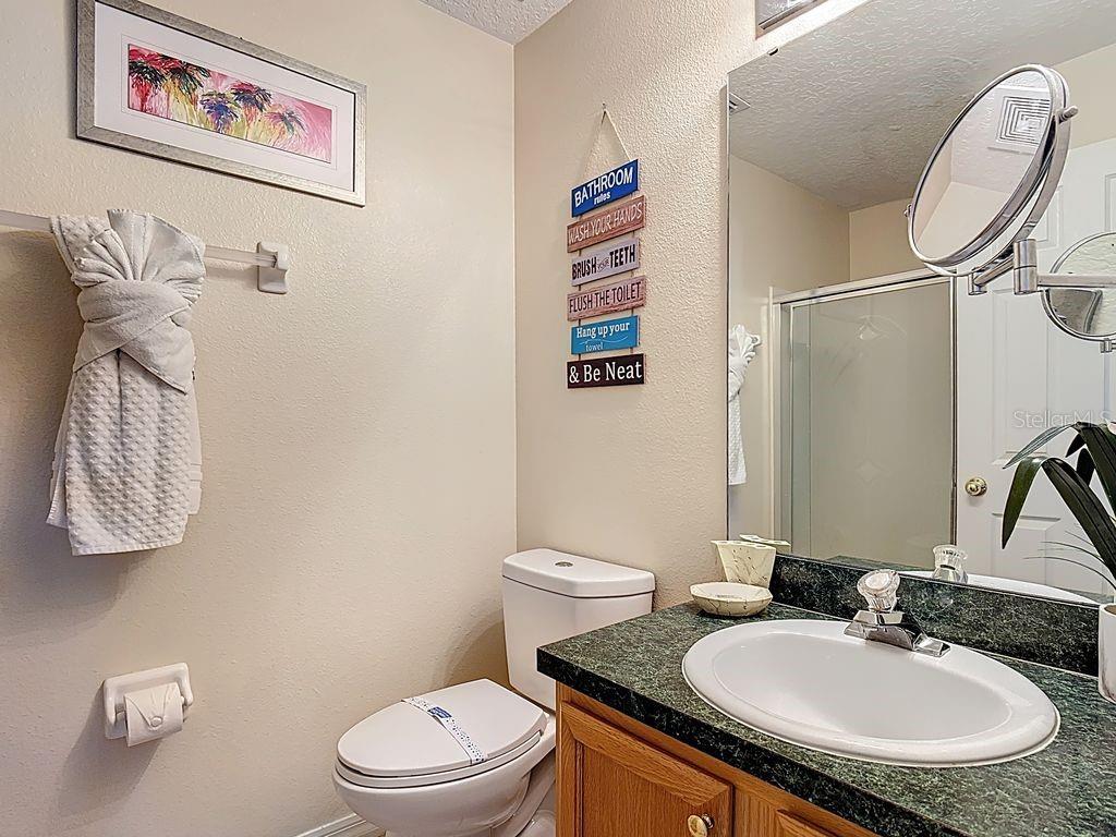 955 Lake Berkley Drive Kissimmee, FL 34746 - Photo 35 of 57 a bathroom with a sink a toilet and a mirror