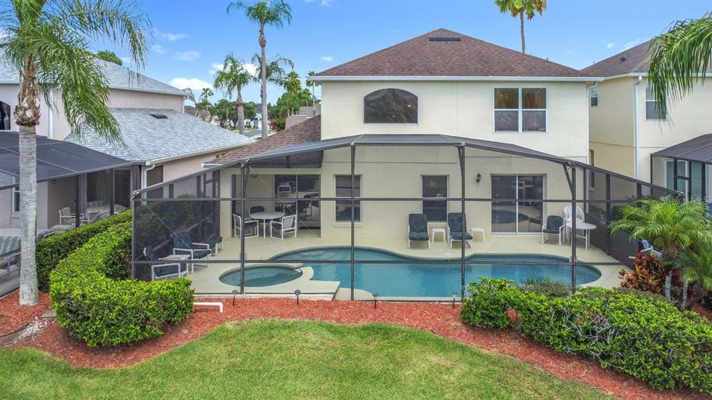955 Lake Berkley Drive Kissimmee, FL 34746 - Photo 47 of 57 a view of a house with a yard potted plants and a table chair