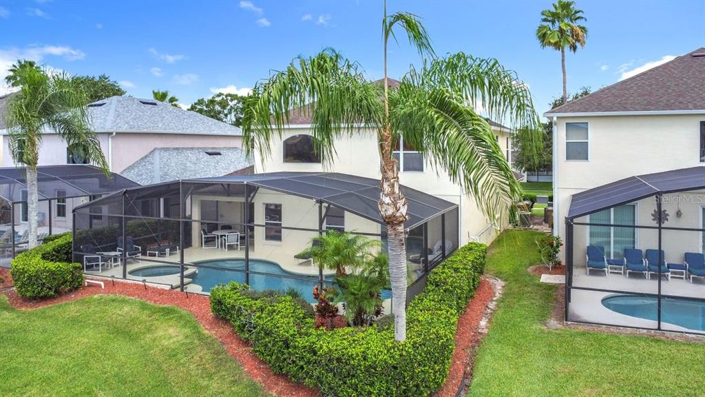 955 Lake Berkley Drive Kissimmee, FL 34746 - Photo 48 of 57 a front view of a house with a garden and plants