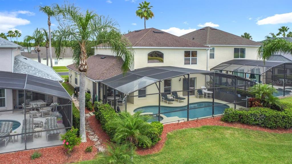 955 Lake Berkley Drive Kissimmee, FL 34746 - Photo 49 of 57 a front view of a house with a garden and plants