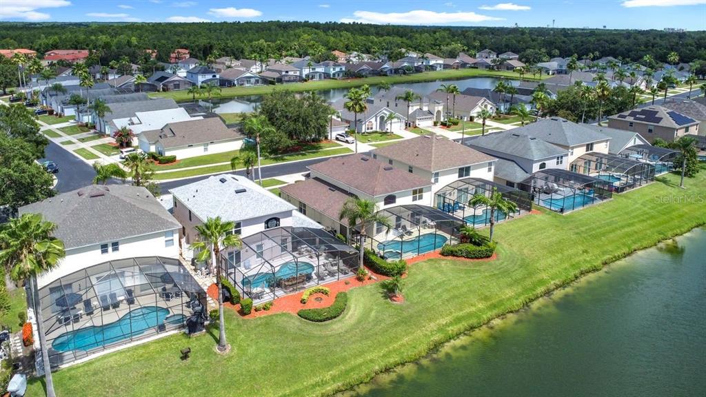 955 Lake Berkley Drive Kissimmee, FL 34746 - Photo 52 of 57 an aerial view of a house with garden space and lake view