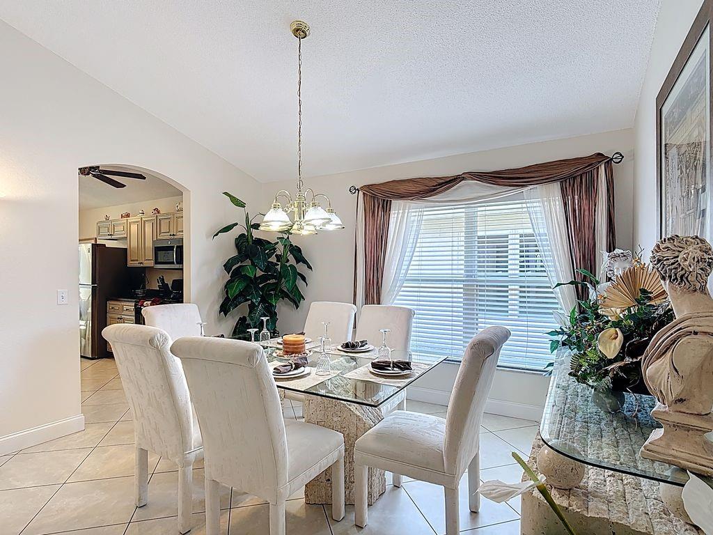 955 Lake Berkley Drive Kissimmee, FL 34746 - Photo 6 of 57 a view of a dining room with furniture window and outside view