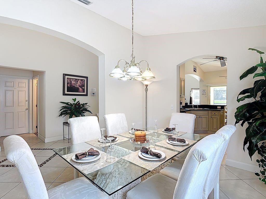955 Lake Berkley Drive Kissimmee, FL 34746 - Photo 7 of 57 a living room with furniture and a chandelier