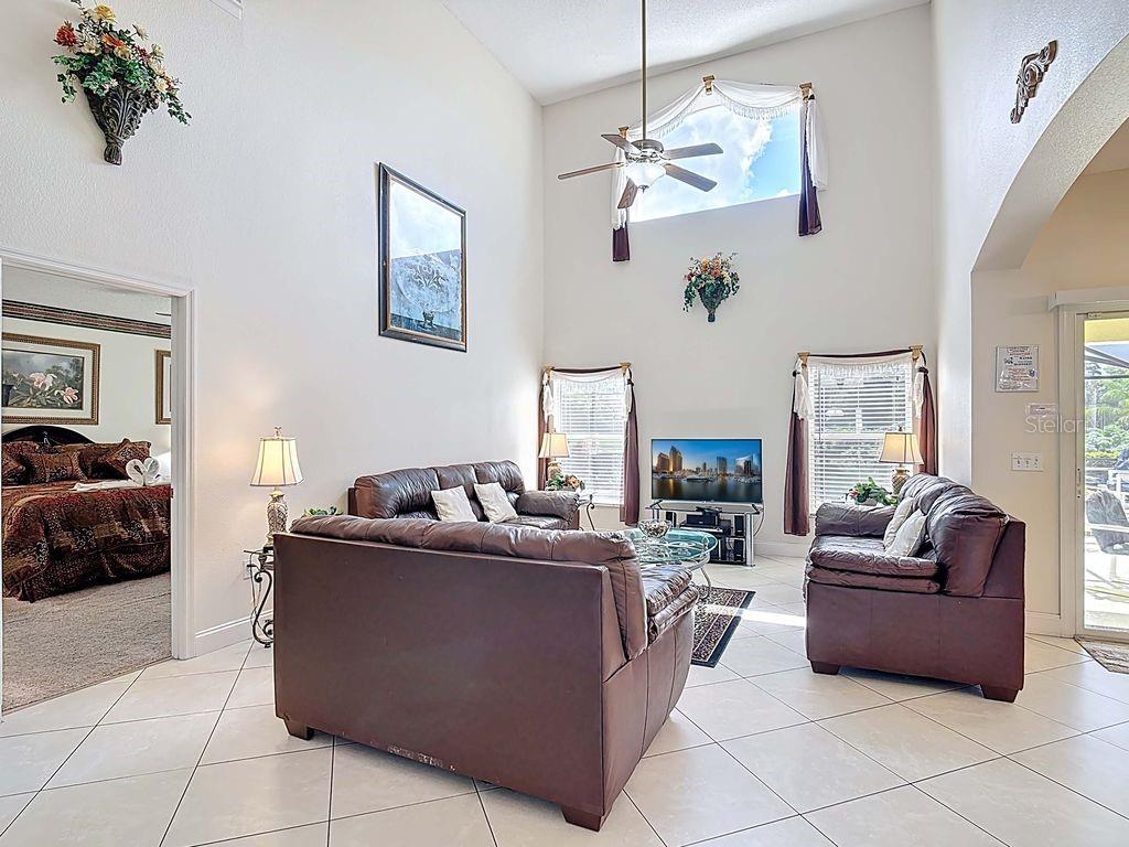 955 Lake Berkley Drive Kissimmee, FL 34746 - Photo 8 of 57 a living room with fireplace furniture and a chandelier