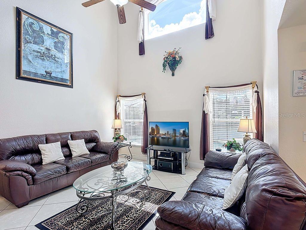 955 Lake Berkley Drive Kissimmee, FL 34746 - Photo 9 of 57 a living room with furniture or couch and a flat screen tv