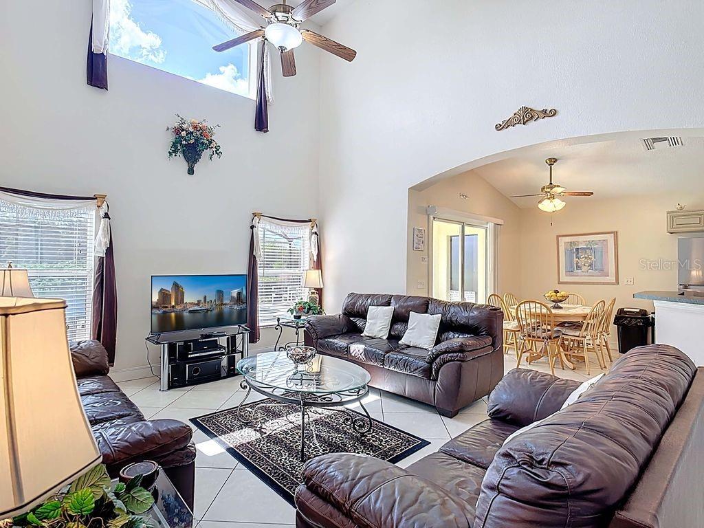 955 Lake Berkley Drive Kissimmee, FL 34746 - Photo 10 of 57 a living room with furniture or couch and a fireplace