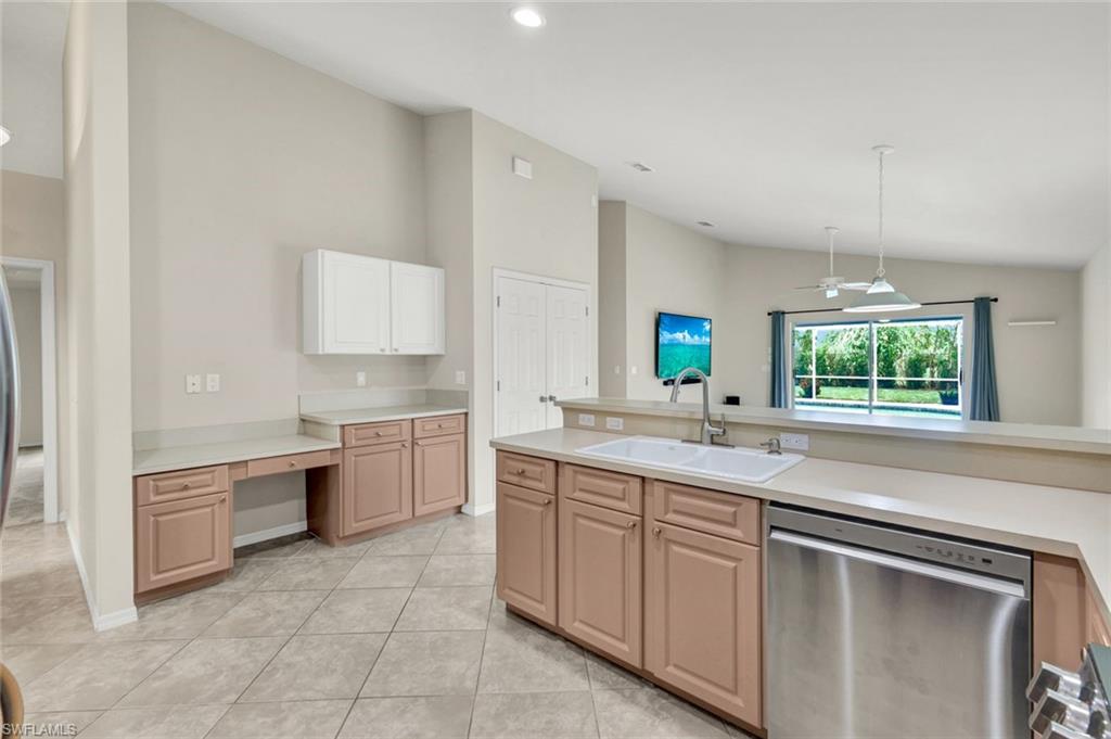 15645 Beachcomber Avenue Fort Myers, FL 33908 - Photo 11 of 33 a kitchen with a sink stove and cabinets