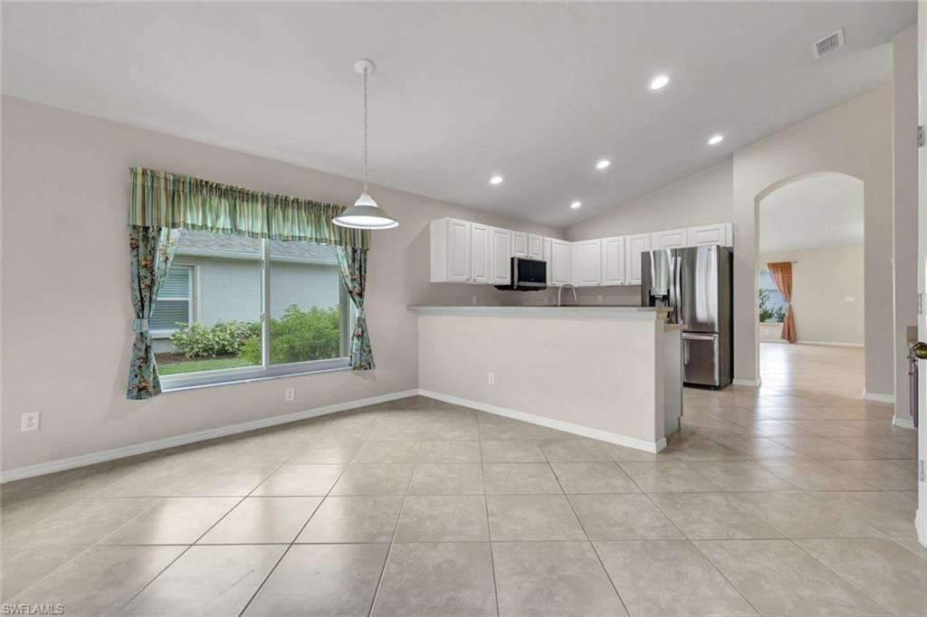15645 Beachcomber Avenue Fort Myers, FL 33908 - Photo 14 of 33 a kitchen with a refrigerator and a sink
