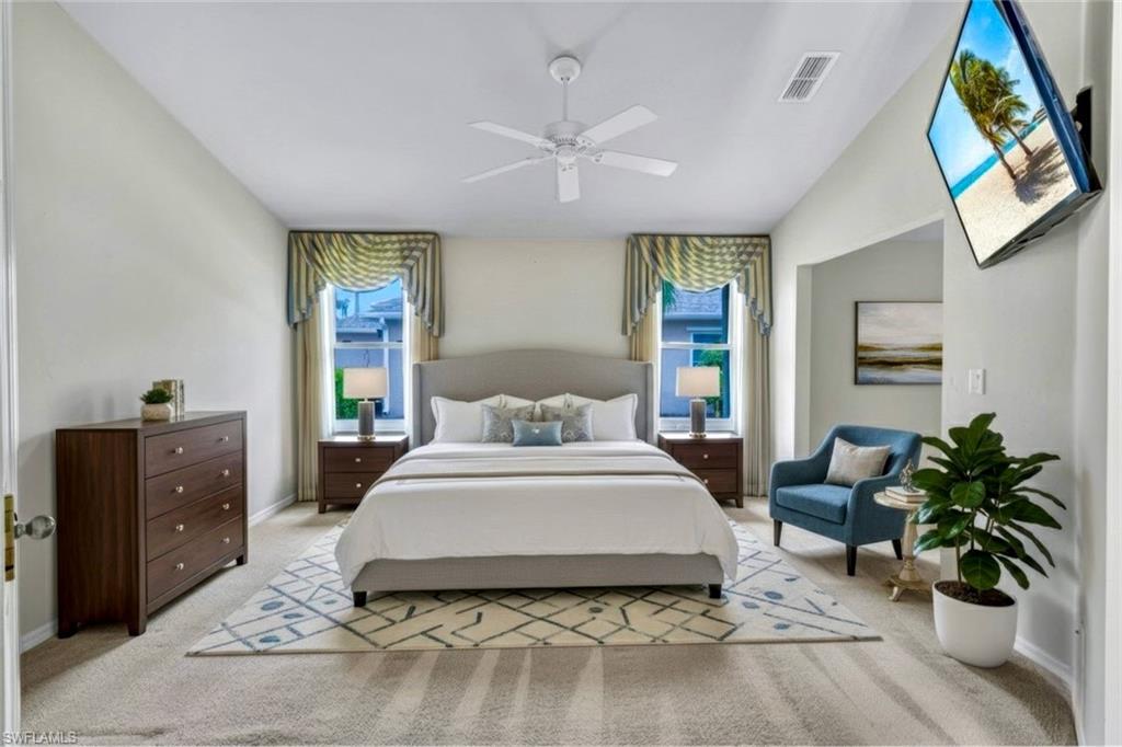 15645 Beachcomber Avenue Fort Myers, FL 33908 - Photo 17 of 33 a spacious bedroom with a large bed and a potted plant