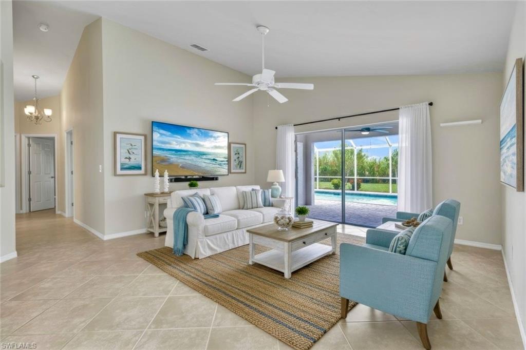 15645 Beachcomber Avenue Fort Myers, FL 33908 - Photo 6 of 33 a living room with furniture flat screen tv and a large window