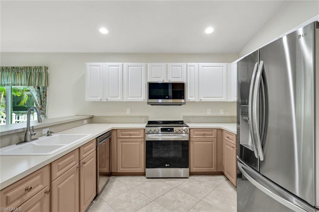 15645 Beachcomber Avenue Fort Myers, FL 33908 - Photo 9 of 33 a kitchen with a sink stove and refrigerator