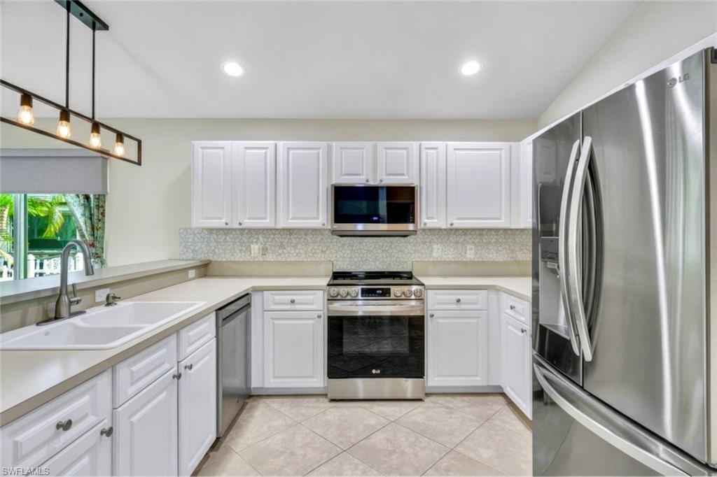15645 Beachcomber Avenue Fort Myers, FL 33908 - Photo 10 of 33 a kitchen with a sink stove and refrigerator