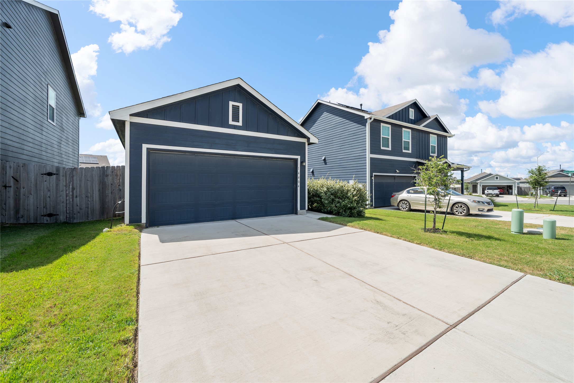 14404 Berning Road Manor, TX 78653 - Photo 1 of 38 A deep blue siding and clean concrete driveway offer a polished curb appeal.