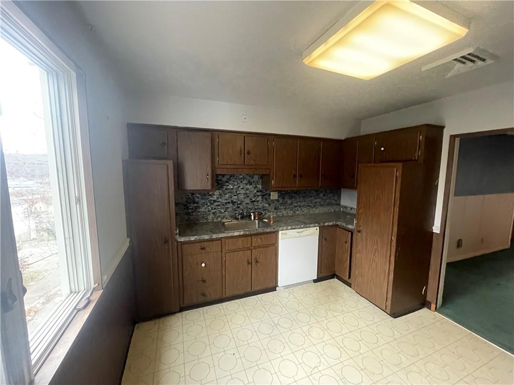 701 Thompson Avenue Donora, PA 15033 - Photo 13 of 36 a kitchen with stainless steel appliances granite countertop a refrigerator and a sink
