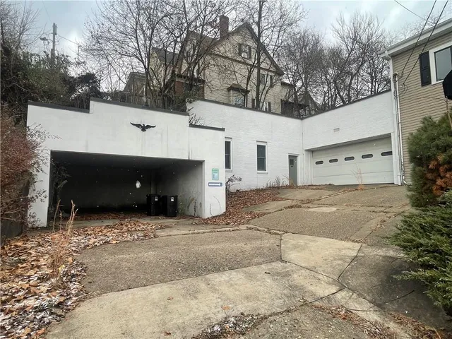 a view of a house with a yard and garage