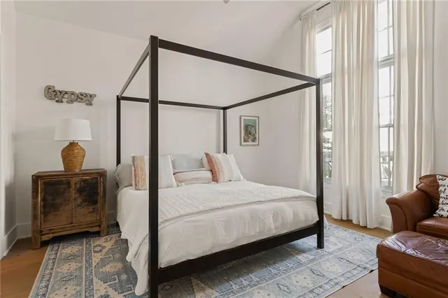 a bedroom with a bed and wooden floor