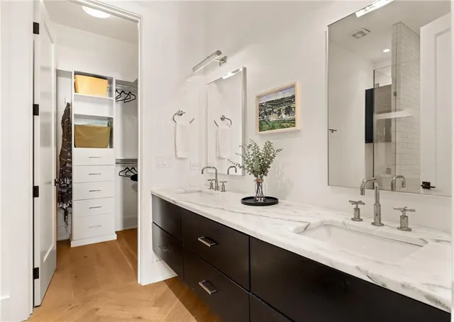 a bathroom with a sink double vanity and a shower