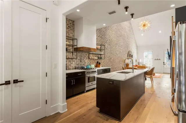 a kitchen with a sink stove and refrigerator