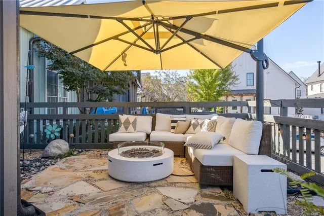 a view of a patio with a table and chairs potted plants