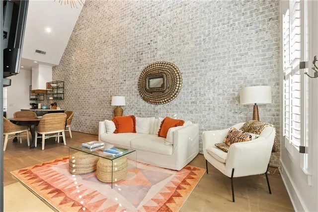 a living room with furniture a rug and a wall painting