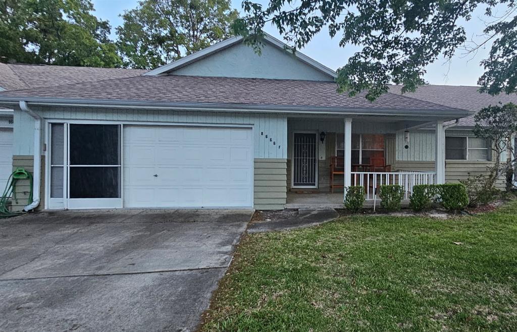 a view of a house with a yard and garage