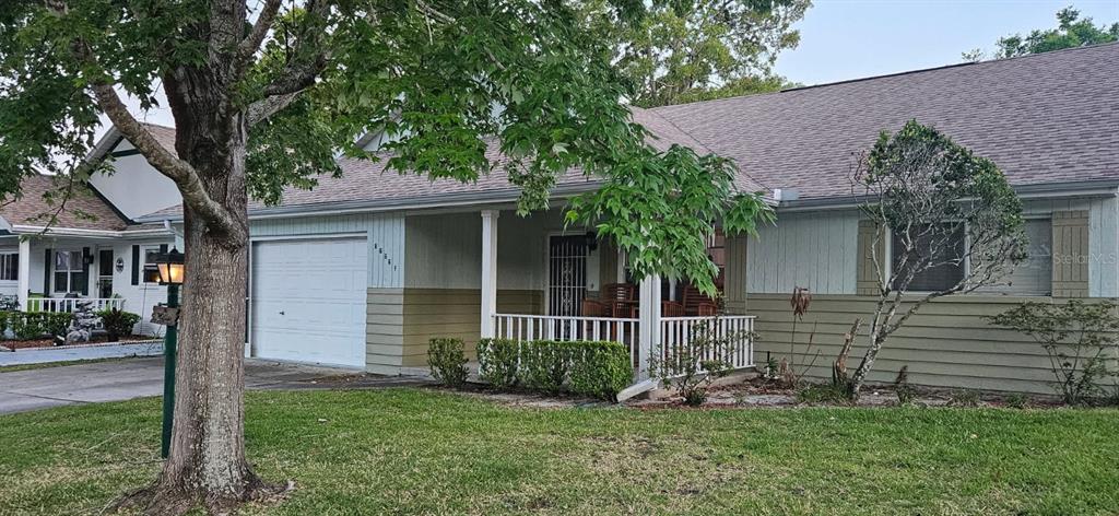 8666 Southwest 92nd Lane, Unit F Ocala, FL 34481 - Photo 2 of 12 a front view of a house with a garden and yard