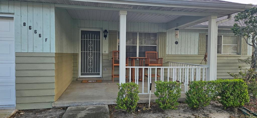 8666 Southwest 92nd Lane, Unit F Ocala, FL 34481 - Photo 4 of 12 a porch with seating space