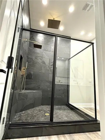 a bathroom with a glass shower door
