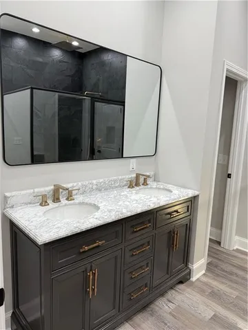 a bathroom with a double vanity sink and a mirror