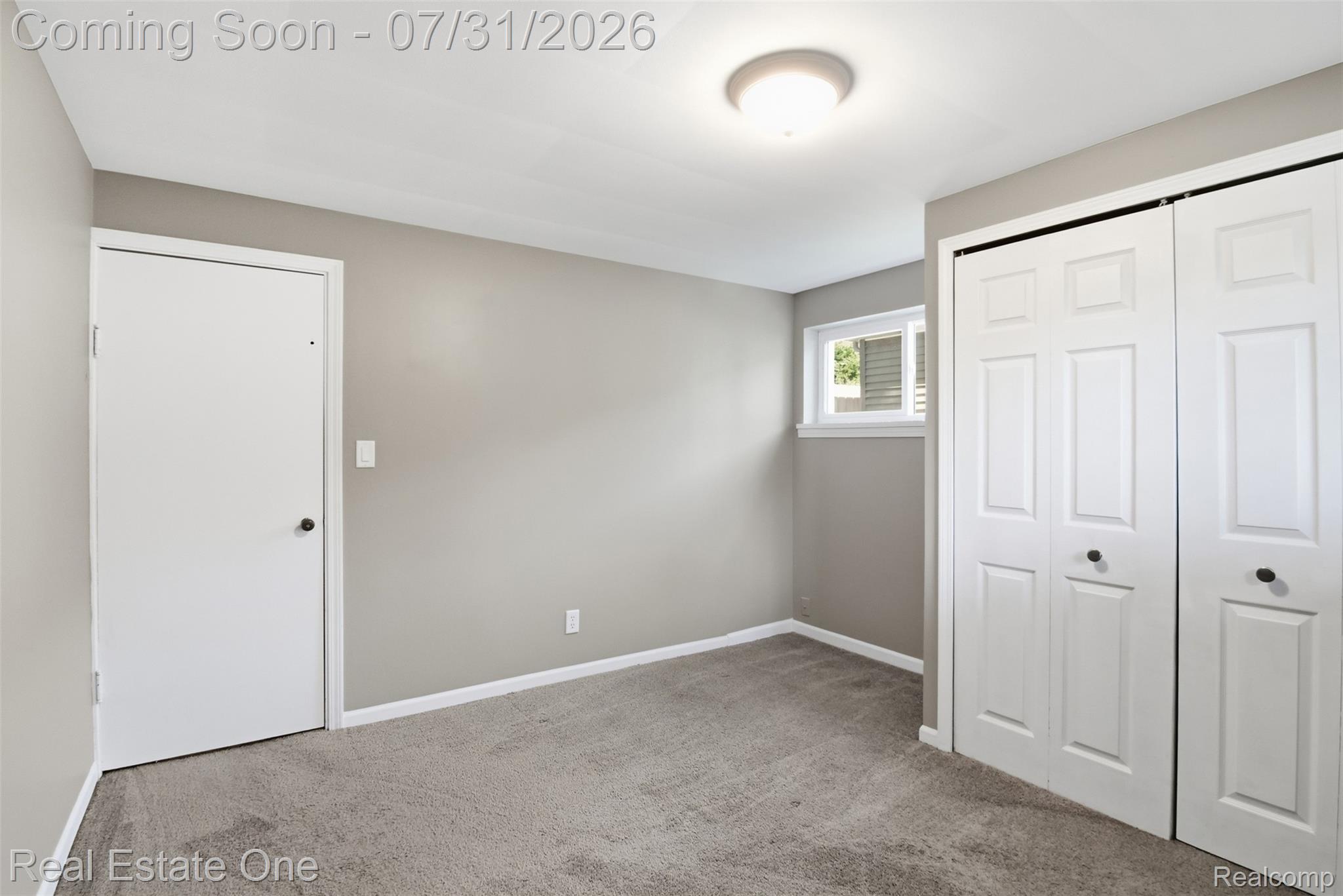 1615 South Commerce Road Walled Lake, MI 48390 - Photo 22 of 34 Neutral-toned room featuring light gray walls and plush gray carpeting