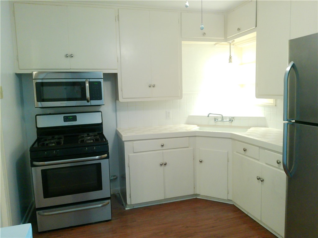 1017 Sorrell Street Corpus Christi, TX 78404 - Photo 6 of 16 a kitchen with a stove microwave and refrigerator