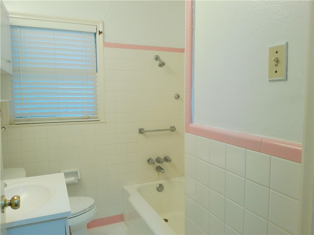 1017 Sorrell Street Corpus Christi, TX 78404 - Photo 9 of 16 a bathroom with a bathtub and a toilet