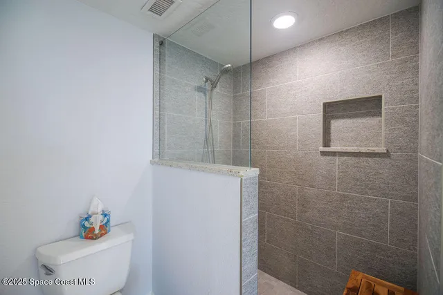a bathroom with a shower and a sink
