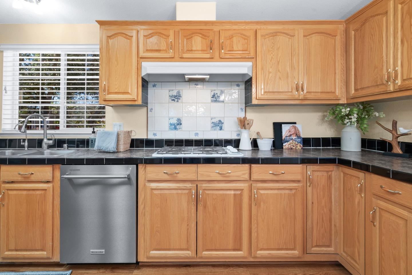552 Bean Creek Road Scotts Valley, CA 95066 - Photo 26 of 76 a kitchen with stainless steel appliances granite countertop a sink and cabinets with wooden floor