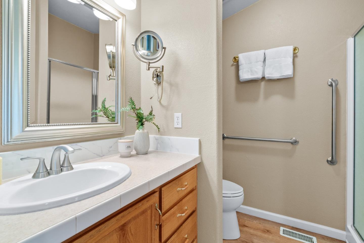 552 Bean Creek Road Scotts Valley, CA 95066 - Photo 45 of 76 a bathroom with a granite countertop sink toilet a mirror and shower