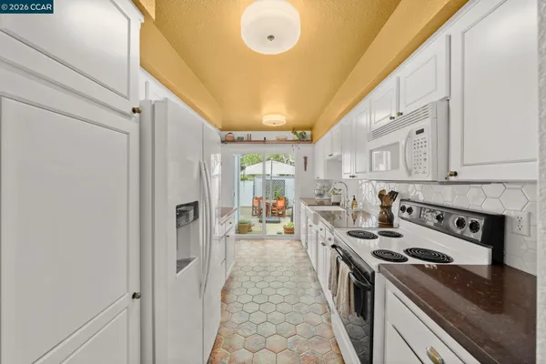 a kitchen with stainless steel appliances granite countertop a stove and a refrigerator
