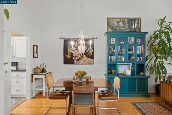 a dining room with furniture and wooden floor
