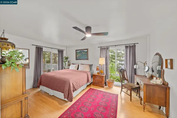 a bedroom with a bed and a large window