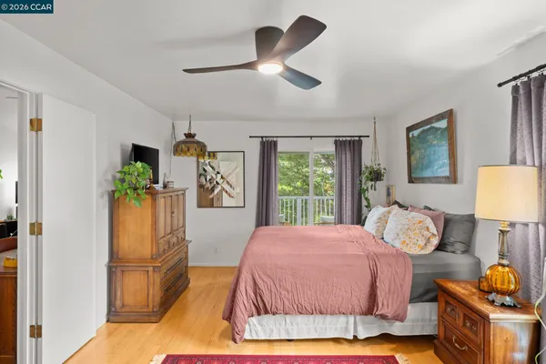 a bedroom with a bed mirror and window