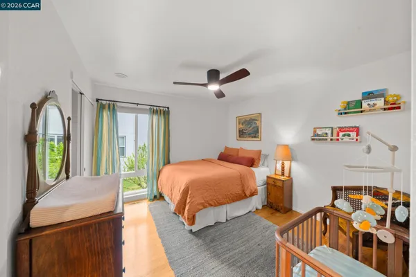 a bedroom with 2 bed and a window