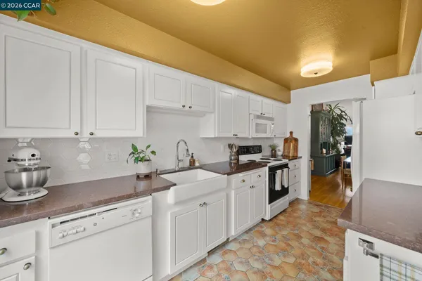 a kitchen with sink cabinets and appliances